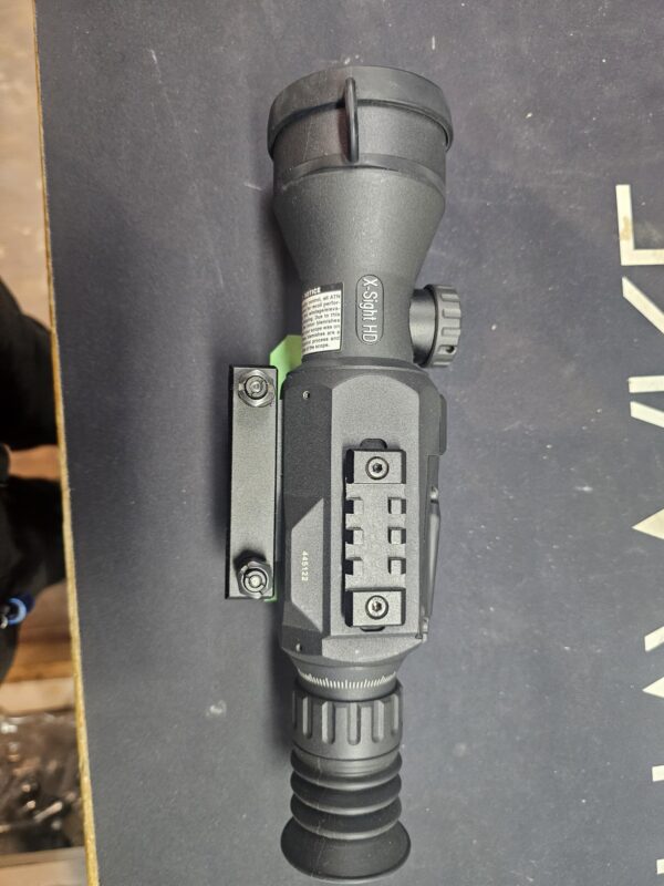 A night vision scope with a mounting bracket and adjustable focus.